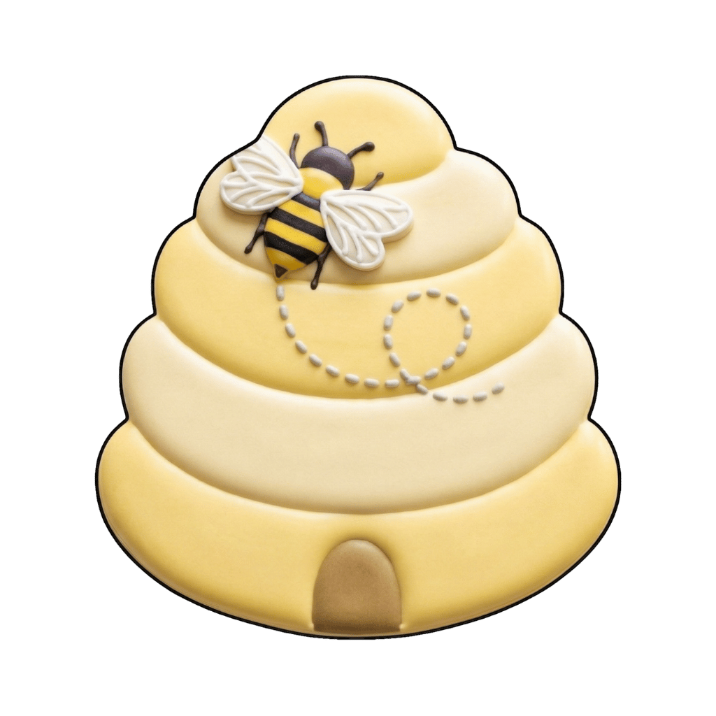 Soft yellow beehive cookie with a flying bee on top, dotted flight trail, and small hive opening