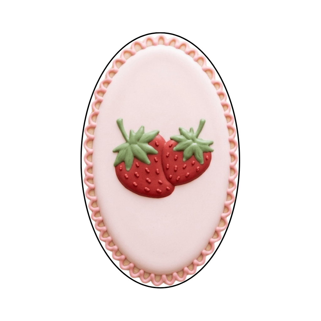 Oval blush plaque cookie with scalloped edge and two small strawberries in the center