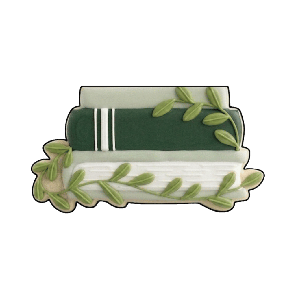 Two stacked green and white books with trailing greenery