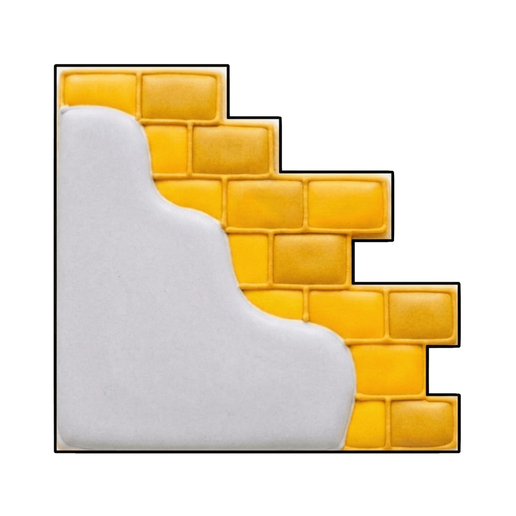 Yellow brick wall plaque cookie with a white curved frosting area