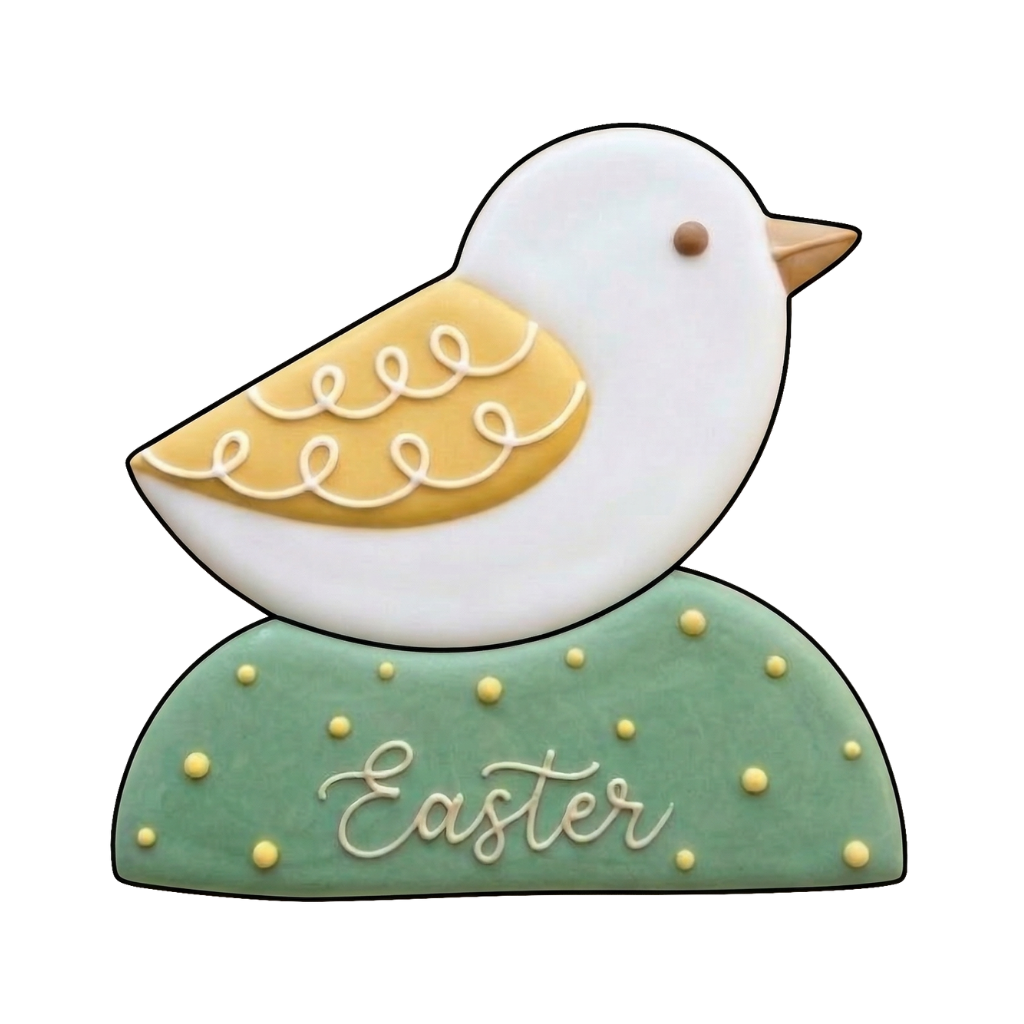 White bird cookie with yellow wing perched on a sage green Easter plaque