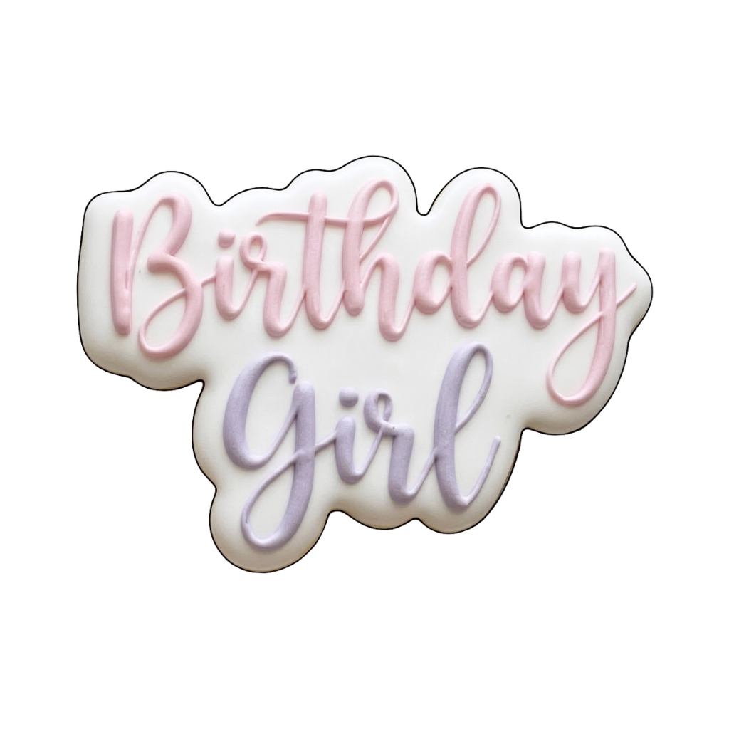 Birthday Girl plaque cookie with pink and lavender script lettering on a white scalloped base