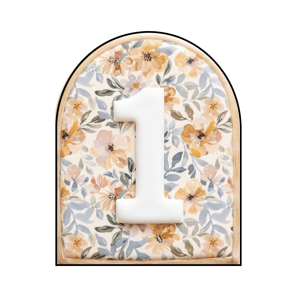Arched plaque cookie with a floral print background and a raised white number 1 in the center